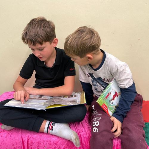 Lesende Kinder beim Büchermarkt im Turnsaal